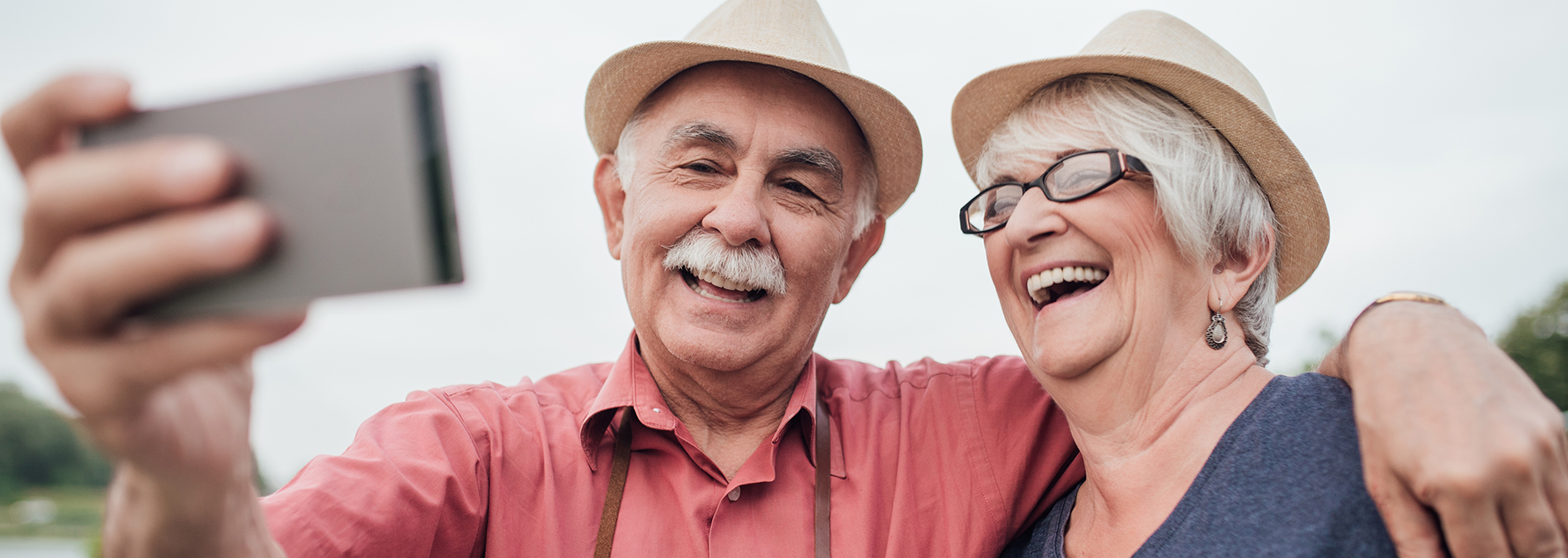 Couple in starw hats happy with their denture services
